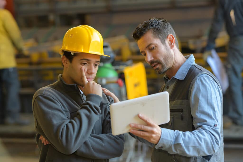 foreman explaining to employee with tablet